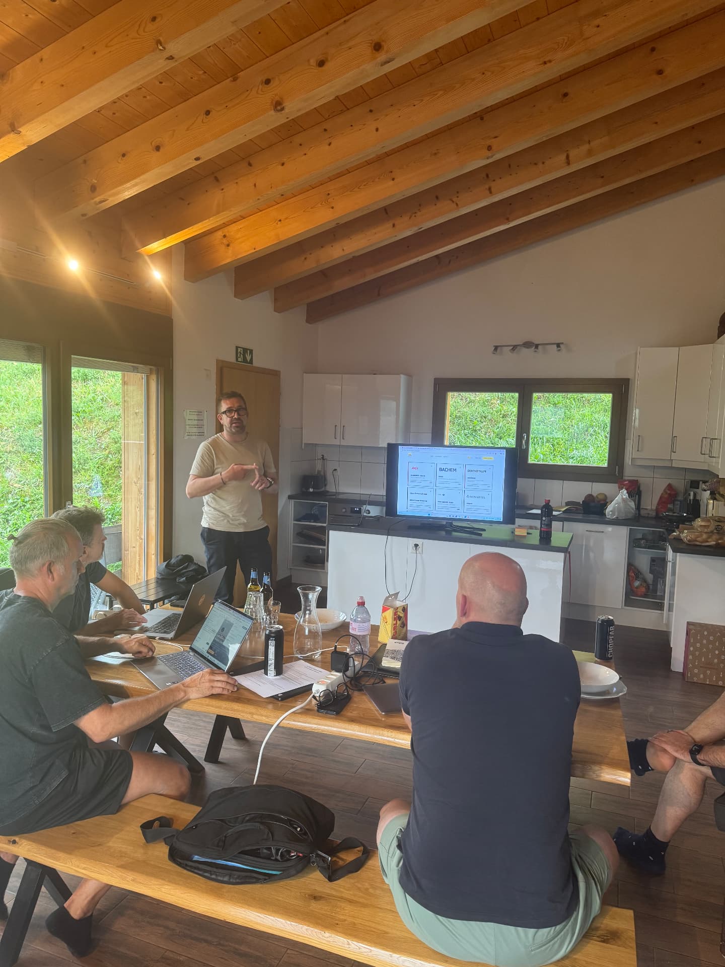 Participants working on laptops during a VibeMountain session in the chalet